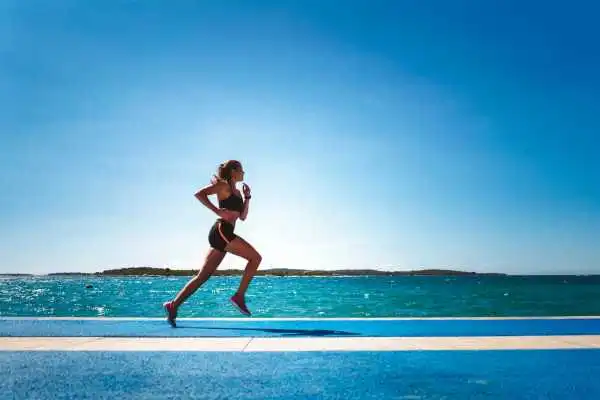 Woman running showing strong leg muscle Hounslow
